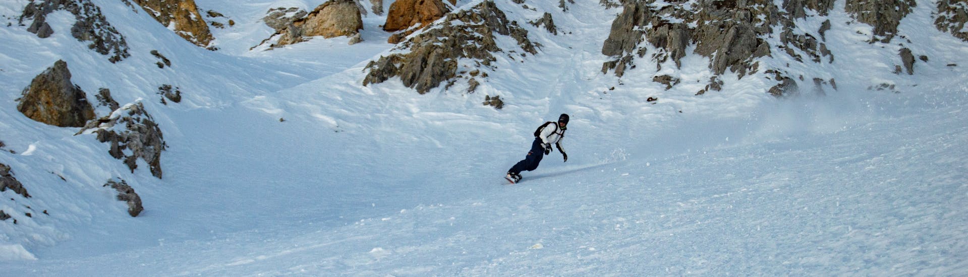 Un snowboardeur explore la montangne durant son Cours particulier de snowboard (dès 8 ans) avec Evolution 2 Tignes