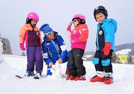 Kids playing in the snow during "Junior Club" with Ski School Dobbiaco