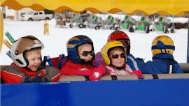 A group of kids smiling during their Kids Ski Lessons “Murmis Mini Club” (2½-4 y.) for Beginners from Ski School Ski Total Kirchdorf.