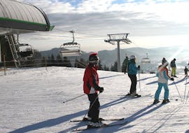 Een volwassen skiër krijgt de volledige aandacht van zijn skileraar tijdens de cursus Privélessen skiën voor kinderen - Alle niveaus van Skischule Snow & Bike Factory Willingen.