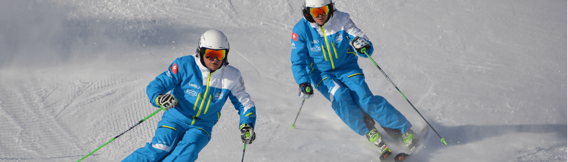 Two skiers ski down the slope during the private kids ski lessons with the Silvaplana Top Snowsports ski school.