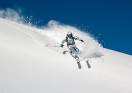 A skier speeds down off-piste during the private freeride course for adults of all levels with Silvaplana Top Snowsports ski school.