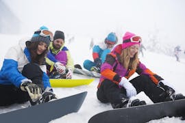 Een groep snowboarders tijdens hun snowboardlessen voor volwassenen op alle niveaus bij skischool Dachstein West in Gosau.