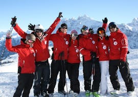 A group of friends is taking a break during the Private Ski Lessons for Teens & Adults of All Levels with Redcarpet swiss snowsports in Leukerbad.