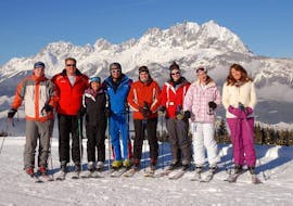 A group of skiers during their adults ski lessons for beginners with ski school Wilder Kaiser in St. Johann.
