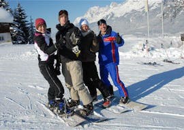 Four snowboarders during their Snowboard Lessons for Kids & Adults (from 10 y.) - Advanced with ski school Wilder Kaiser in St. Johann.