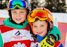 Two kids during the Kids Ski Lessons (4-10 y.) for All Levels with Snow Sports School Eichenhof St. Johann.
