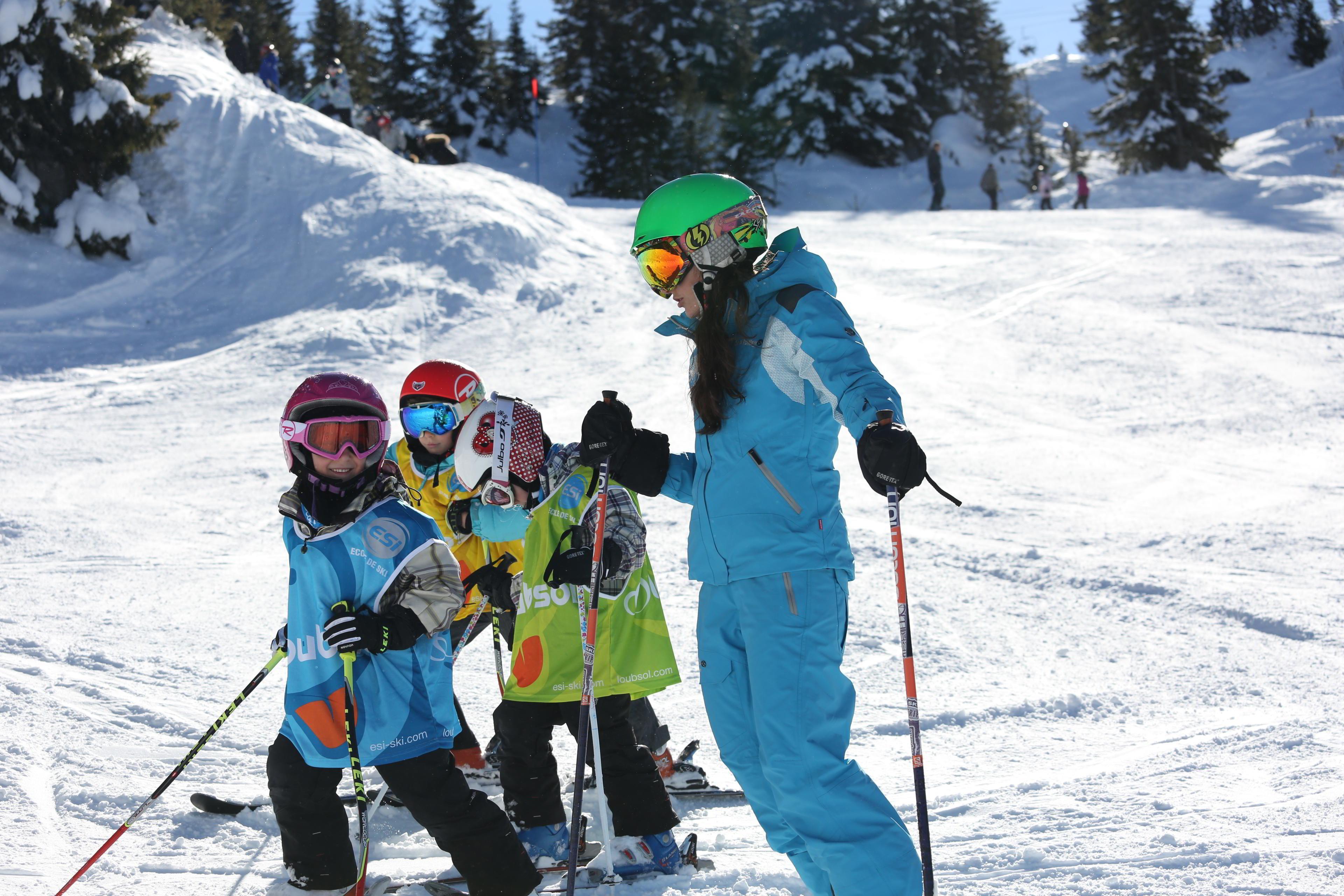 An ESI Ozone instructor guides young skiers during a kids ski lesson for first timers in Les Orres. 