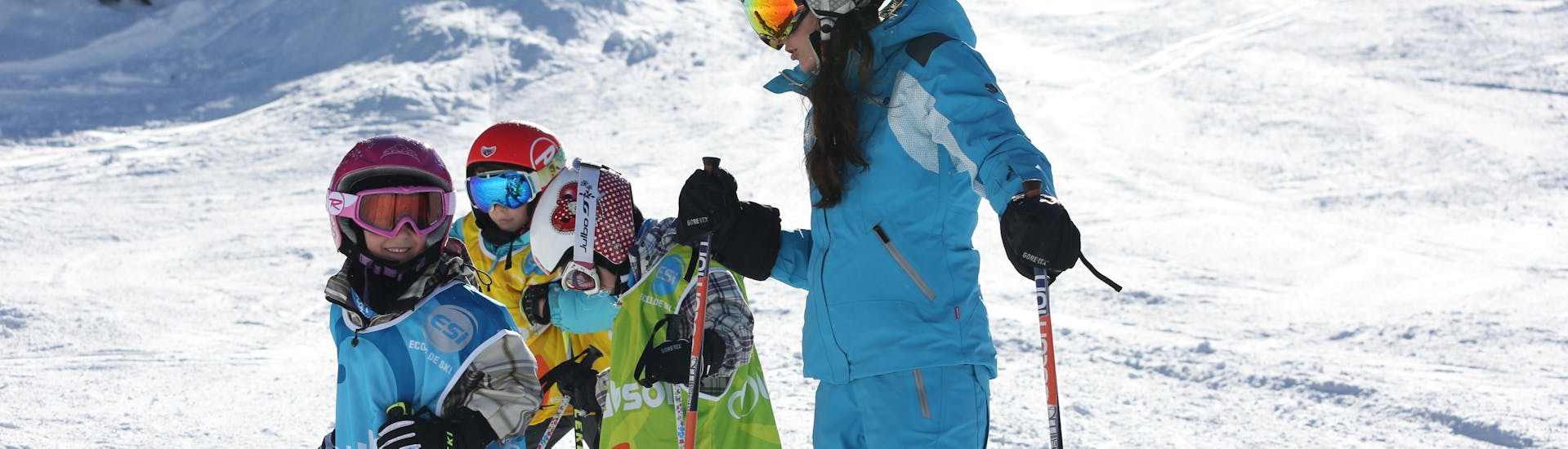 An ESI Ozone instructor guides young skiers during a kids ski lesson for first timers in Les Orres. 