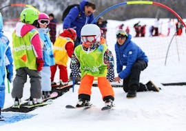 A child makes his first snowplough during a kids ski lesson for first timers with the ESI Ozone in Les Orres. 
