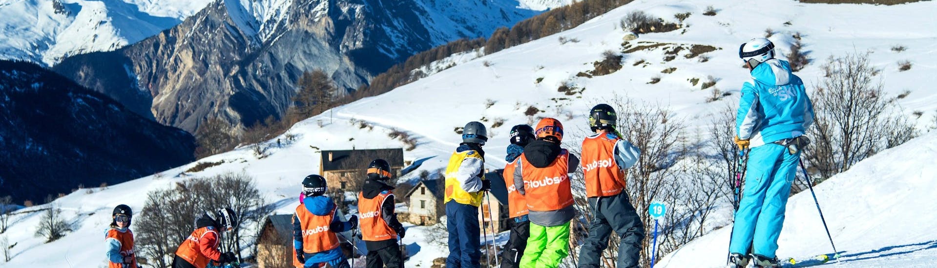 A group of skiers participating in a kids ski lesson at the ESI Ozone in Les Orres. 