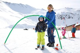 Een jonge skiër leert skiën in de veiligheid van een sneeuwtuin tijdens hun Kinderskiles "Kindergarten" (3-5 jaar) bij de skischool ESI Valfréjus.