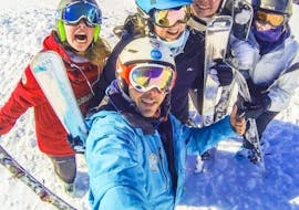 Happy teenagers are taking a selfie with their ski instructor from the ski school ESI Valfréjus before starting their Ski Lessons for Teens (from 13 years) - Advanced.