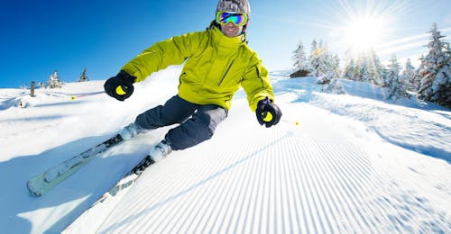 Private Ski Lessons for Kids & Adults (from 7 y.) at Zugspitze from Schneesportschule Morgenstern A young man is improving his skiing technique during Private Ski Lessons for Adults at Zugspitze with the ski school Schneesportschule Morgenstern.