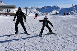 Young kid makes his first steps on ski during a Private Ski Lessons for Kids & Teens of All Ages with Ski Cool St. Moritz.