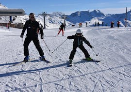 Young kid makes his first steps on ski during a Private Ski Lessons for Kids & Teens of All Ages with Ski Cool St. Moritz.