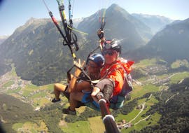 A costumer and his pilot smiling into the camera while Tandem Paragliding Zillertal in Mayrhofen with Fly 2095.