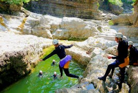 During the canyoning in the almbachklamm for bachelor parties the customers of outdoor center baumgarten is doing a big jump into the river.