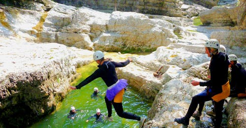 Canyoning voor Vrijgezellenfeesten in het Berchtesgadener Land Tijdens het canyoning in de almbachklamm voor vrijgezellenfeesten doen de klanten van outdoorcentrum baumgarten een grote sprong in de rivier.