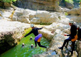 During the canyoning in the almbachklamm for bachelor parties the customers of outdoor center baumgarten is doing a big jump into the river.