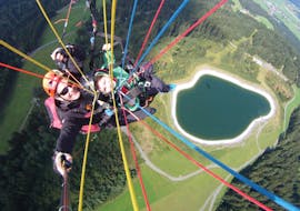 A customer and his guide while Tandem Paragliding from Harschbichl with Mountain High Adventure Center Triol from a bird's eye view. 