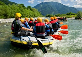 A boat full of people while Rafting on the Tiroler Ache River for Families with Mountain High Adventure Center Tirol.