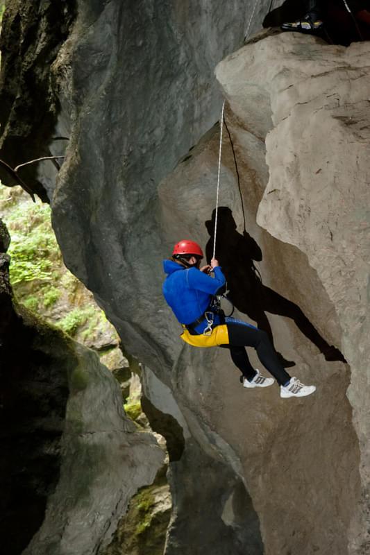 A man while abseiling at the Canyoning in Taxaklamm Tour with Mountain High Adventure Center Tirol