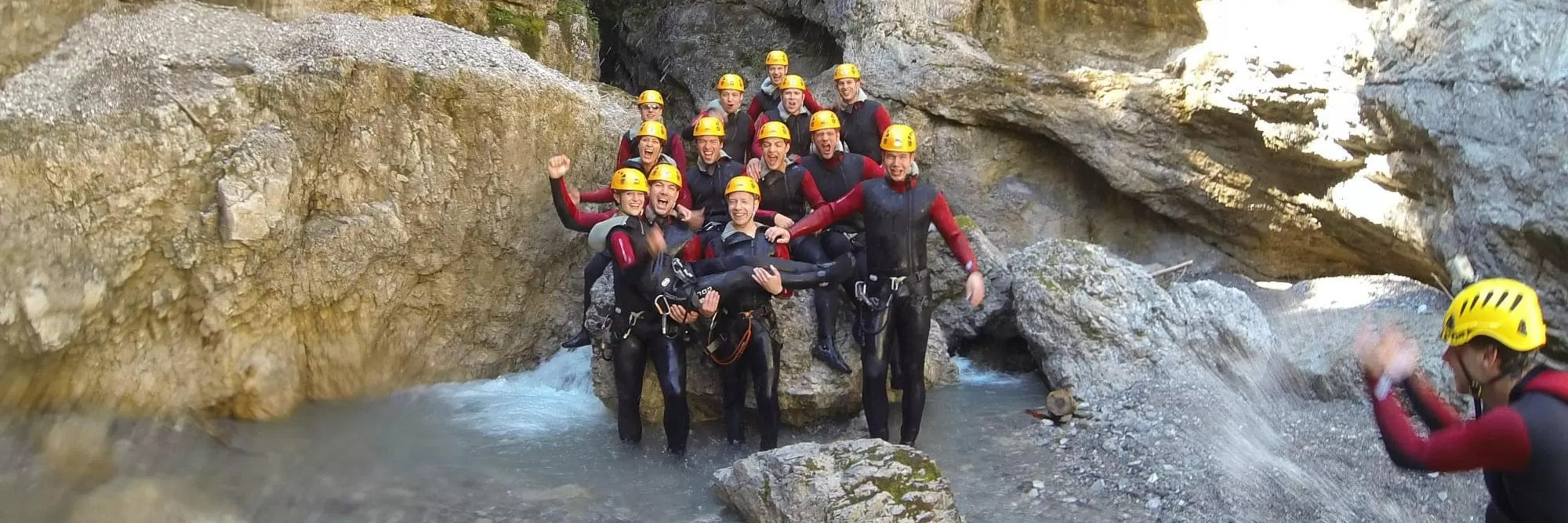 Group picture after an adventurous day while Canyoning in Taxaklamm at Kirchdorf with Mountain High Adventure Center Tirol.