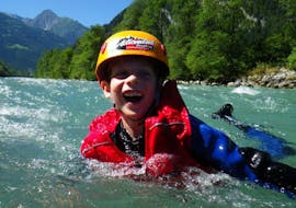 A child having fun in the water while Rafting on the Ziller River for Families near Mayrhofen with Actionclub Zillertal.