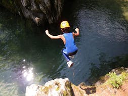 A child jumping into a natural pool during Canyoning in Zemmschlucht for Beginners near Mayrhofen with Actionclub Zillertal.