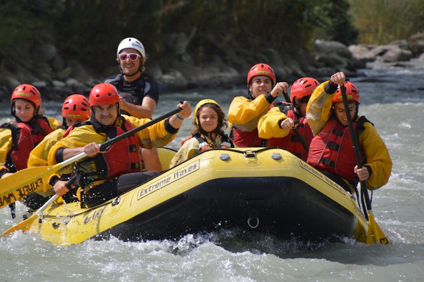 A group in a boat during Rafting on the Noce River in Val di Sole - Family Tour with Extreme Waves.
