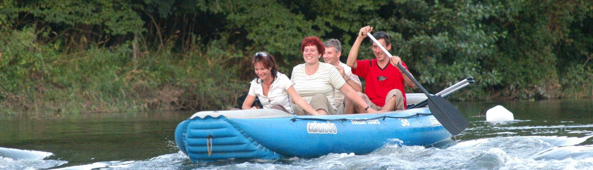 Four people in a raft during Rafting on the Neisse from Zentendorf to Rothenburg - Short with Neisse Tours Rothenburg