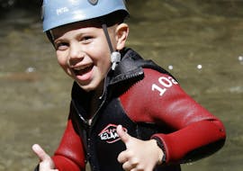 A kid is happy to have participated in his first River Trekking in Canyon de la Basse Besorgue for Famillies with Geo Ardèche Canyon.