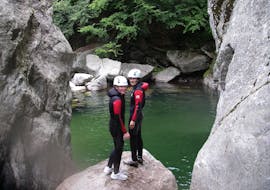 Two friends are getting ready to jump in an emerald pool during their Aquatic Canyoning in Canyon de la Borne with Geo Ardèche Canyon.