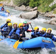 Some friends are enjoying the rafting descent Rafting Rio Claro on the river Noce organized by X Raft Val di Sole.