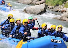 Some friends are enjoying the rafting descent Rafting Rio Claro on the river Noce organized by X Raft Val di Sole.