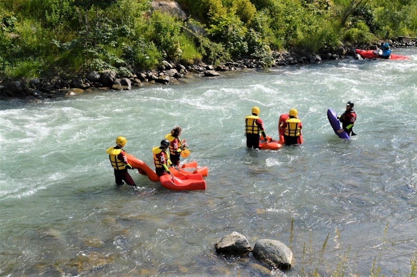 The participants of the Hydrospeed Easy on the river Noce are getting ready to enter the waterduring the activity organized by X Raft Val di Sole.