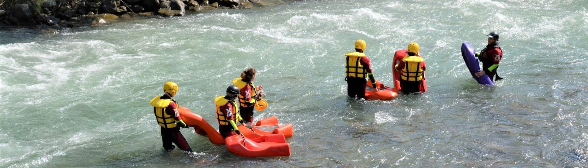 The participants of the Hydrospeed Strong on the river Noce are getting ready to enter the waterduring the activity organized by X Raft Val di Sole.