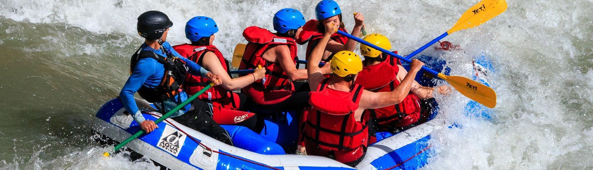 A group of adults and kids are caught in rapids on the Verdon river and are having fun during the Classic rafting descent organized by Yeti Rafting.
