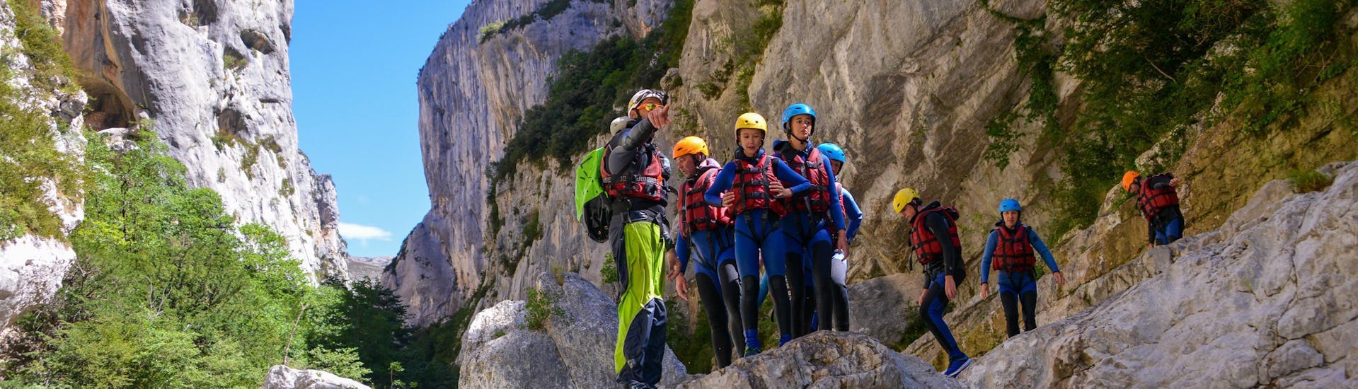 A group of children is getting ready to jump in the emerald waters of the Gorges du Verdon during their river trekking tour "Couloir Samson" with Yeti Rafting.