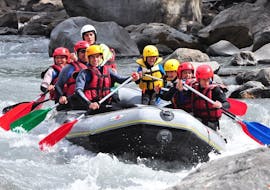 Parents and kids are having fun together while crossing some rapids while Rafting on the Ubaye River for Families with Anaconda Rafting.