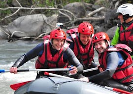 Three friends are spending a good time paddling during their Classic Rafting on the Ubaye River with Anaconda Rafting.