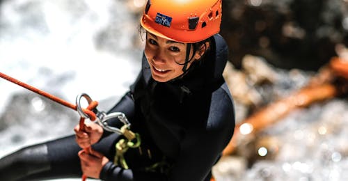 Canyoning in Foresto Canyon - Italian Adventure from SerreChe Canyon A woman is tackling an abseiling passage during her Canyoning in Canyon du Foresto - Italian Adventure tour with SerreChe Canyon.