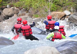 A group is paddling through rapids during their Rafting Combo on the Ubaye River with Anaconda Rafting.