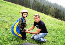 Tandem Paragliding at Punta Cervina - Mid Station Flight with FlyHirzer Saltaus A child is ready for takeoff for his first flight before the Tandem Paragliding at Punta Cervina - Mid Station Flight with FlyHirzer Saltaus.