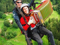 Playing some music during the Paragliding at Punta Cervina - Mountain Station Flight with FlyHirzer Saltusio.