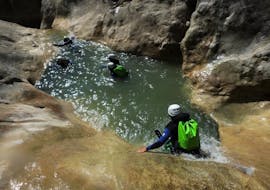 A group in a natural slide during canyoning in the Riolan canyon in summer.