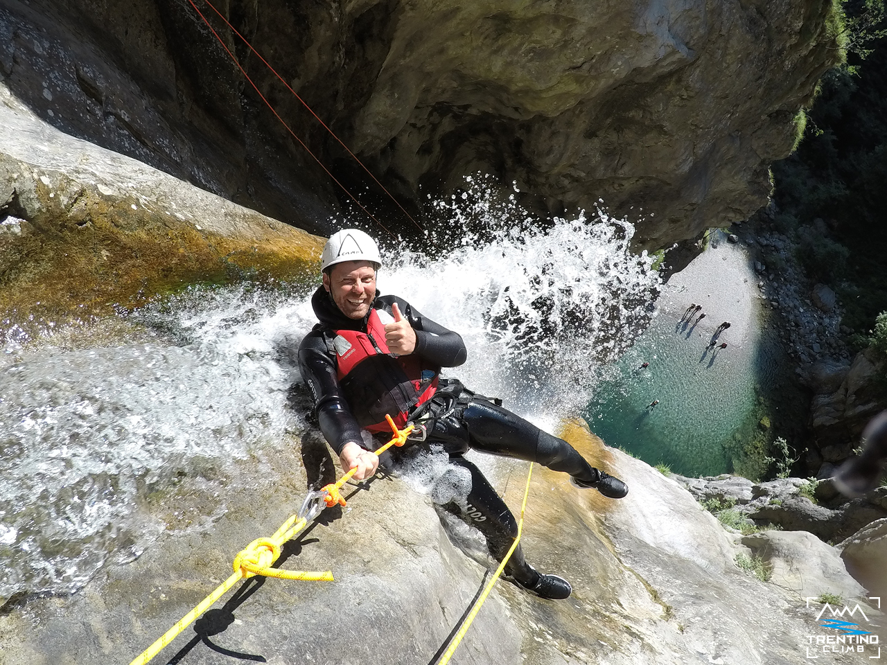 A participant descends into the canyon during Canyoning in Palvico in Pieve di Ledro with Trentino Climb.