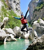 A man jumps into the water during the Half Day River Trekking from Castellane in Couloir Samson.