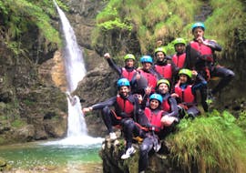 A group of participants of the Canyoning in Rio Nero is posing at the camera on a rock during a canyoning activity organized by LOLgarda.